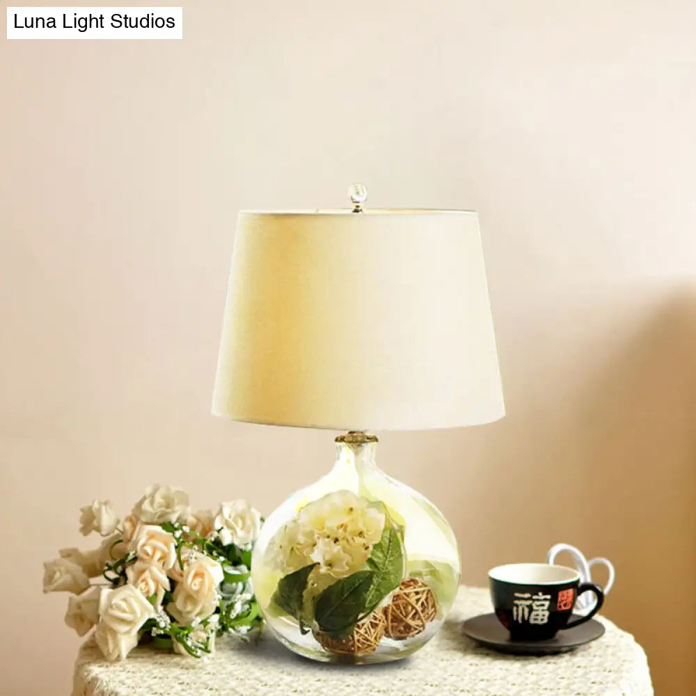 1-Light Fabric White Nightstand Lamp With Industrial Tapered Design And Floral Rattan Ball Decor