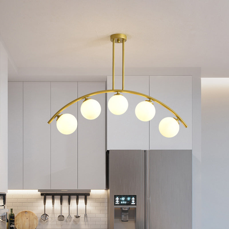 Modern Glass Orb Island Pendant Light With Brass Arch Arm - 5 Bulbs White/Clear Design For Dining