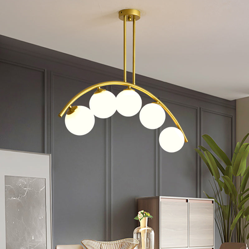 Modern Glass Orb Island Pendant Light With Brass Arch Arm - 5 Bulbs White/Clear Design For Dining