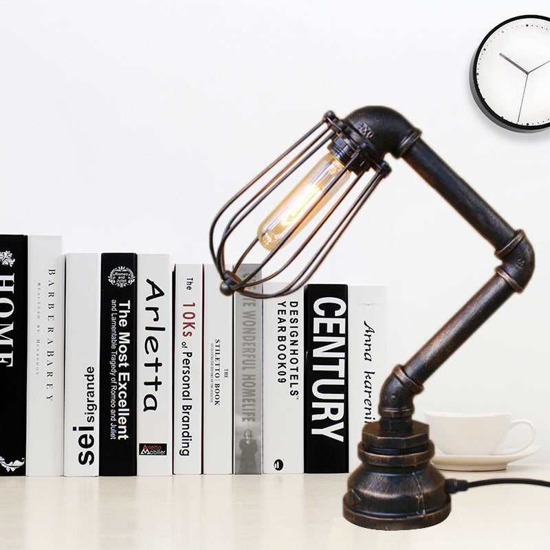 Industrial Style Metal Table Lamp With Bulb Cage Shade & Water Pipe In Aged Bronze Antique