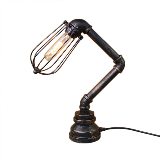 Industrial Style Metal Table Lamp With Bulb Cage Shade & Water Pipe In Aged Bronze