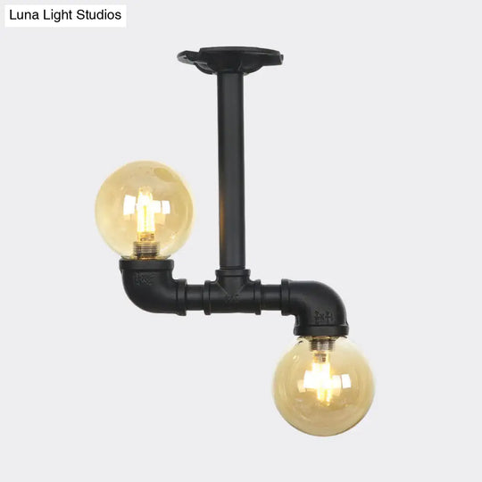 2-Head Semi-Flush Industrial Ball Amber Glass Ceiling Fixture In Black