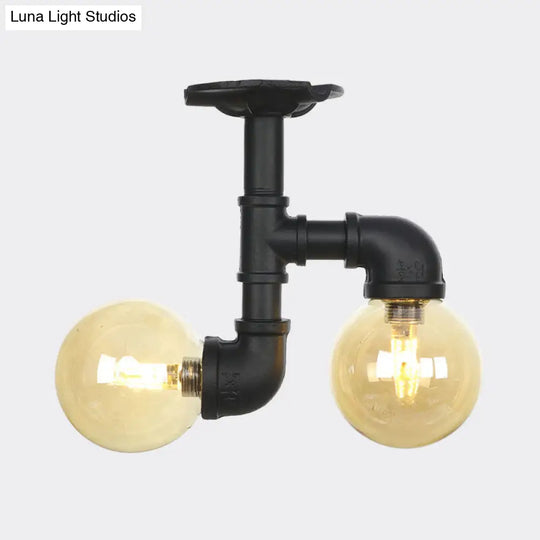 2-Head Semi-Flush Industrial Ball Amber Glass Ceiling Fixture In Black