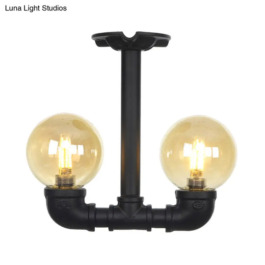 2-Head Semi-Flush Industrial Ball Amber Glass Ceiling Fixture In Black