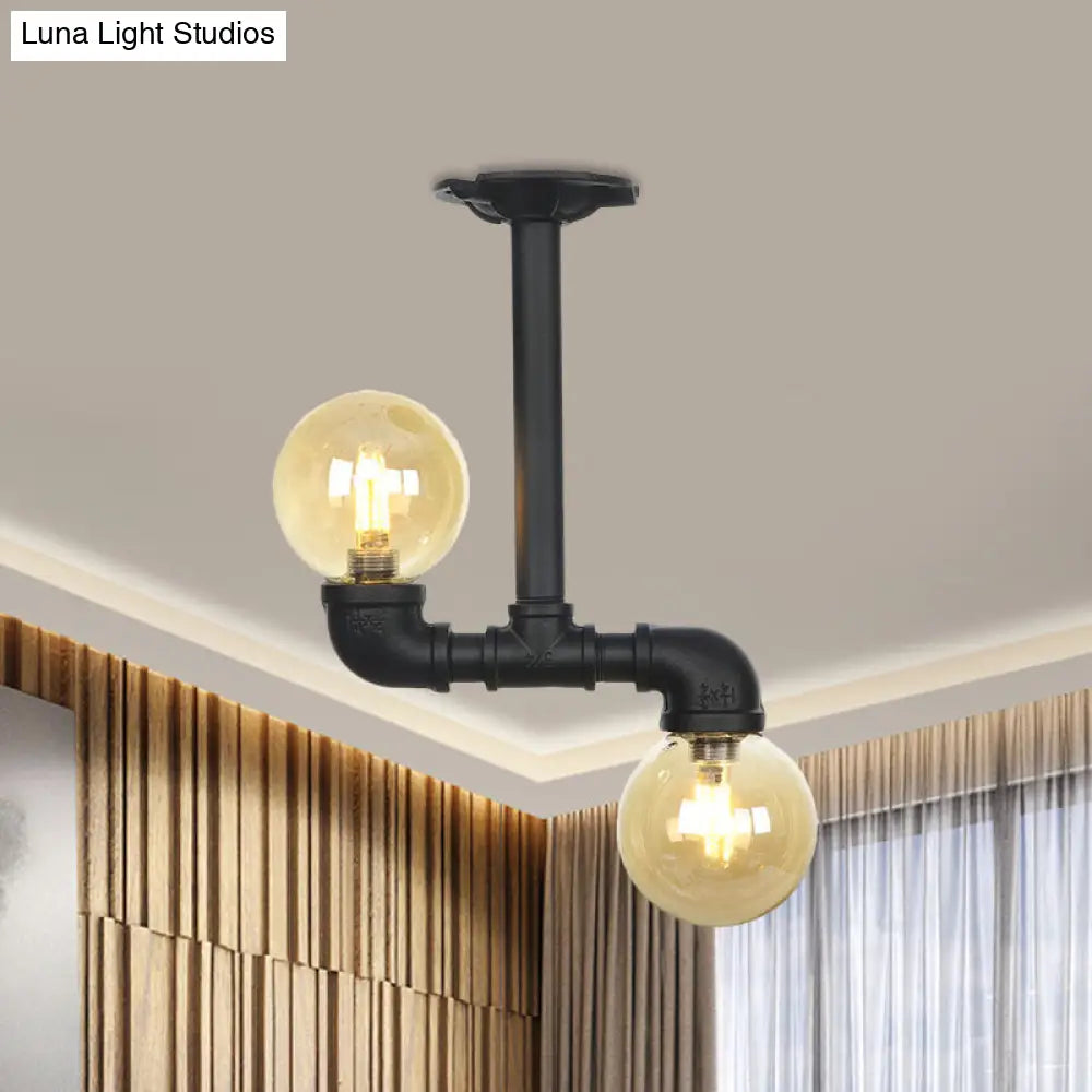 2-Head Semi-Flush Industrial Ball Amber Glass Ceiling Fixture In Black