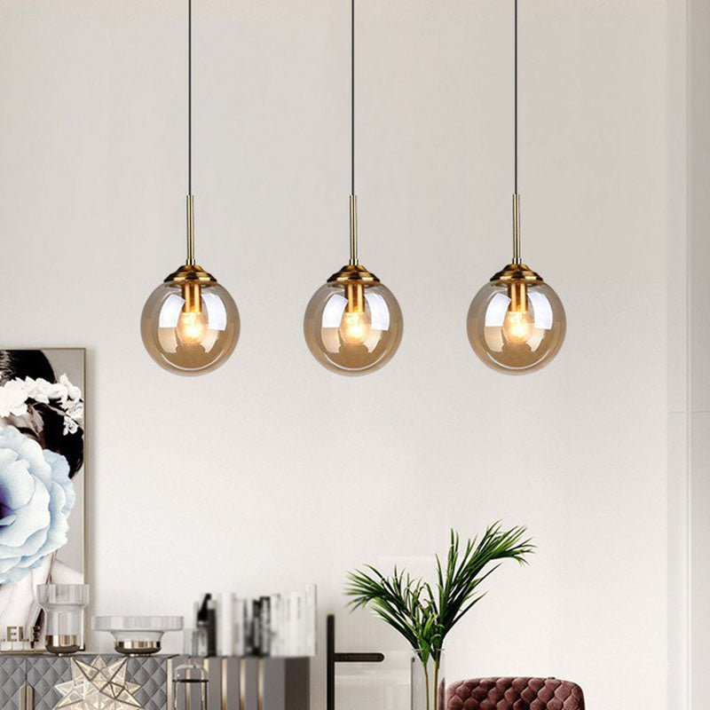 Sleek Glass 3-Bulb Spherical Ceiling Light Fixture In Brass For Minimalistic Dining Rooms Amber