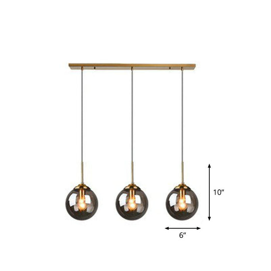 Sleek Glass 3-Bulb Spherical Ceiling Light Fixture In Brass For Minimalistic Dining Rooms