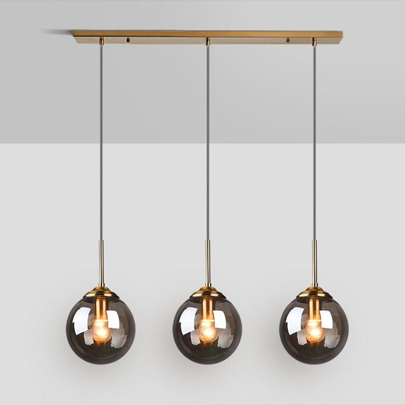 Sleek Glass 3-Bulb Spherical Ceiling Light Fixture In Brass For Minimalistic Dining Rooms