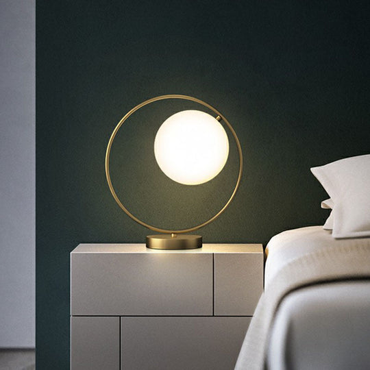 White Glass Ball Bedside Lamp With Gold Ring Decor - Single Minimalistic Table Light
