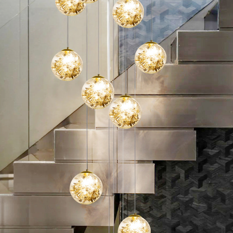 Minimalist Clear Glass Sphere Chandelier With Gold Metal Flower Decor - 10-Head Stairs Pendant Lamp