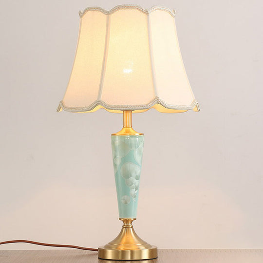 Blue Fabric Table Lamp With Scalloped Shade For A Classic Nighttime Glow