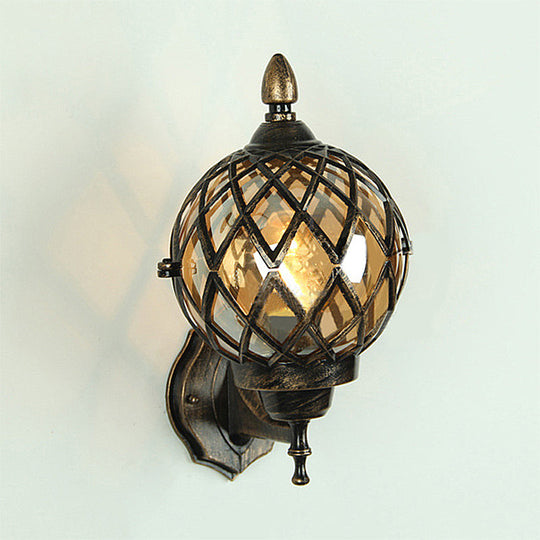 Amber Glass Wall Sconce With Industrial Cage And Black Globe For Dining Room Lighting