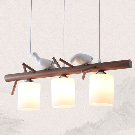 Contemporary Wood Island Pendant With Nutcracker Design And Cylindrical Glass Shades - Set Of 3