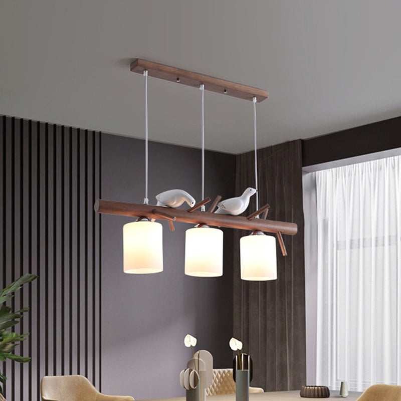 Contemporary Wood Island Pendant With Nutcracker Design And Cylindrical Glass Shades - Set Of 3