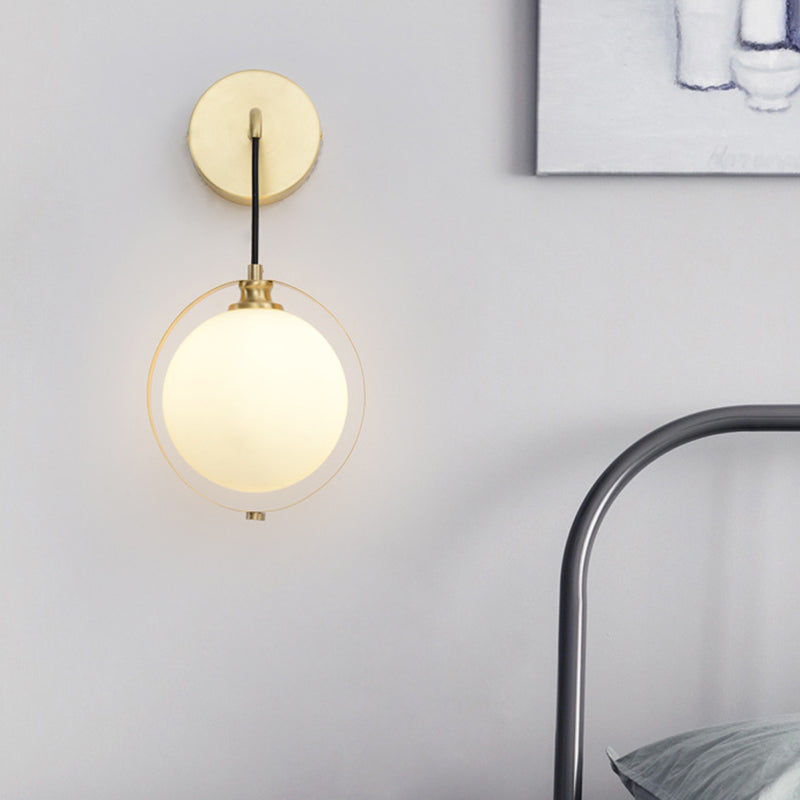 Modern White Glass Ball Sconce Light With Brass Wall Mount And Curved Arm - 1 Bulb