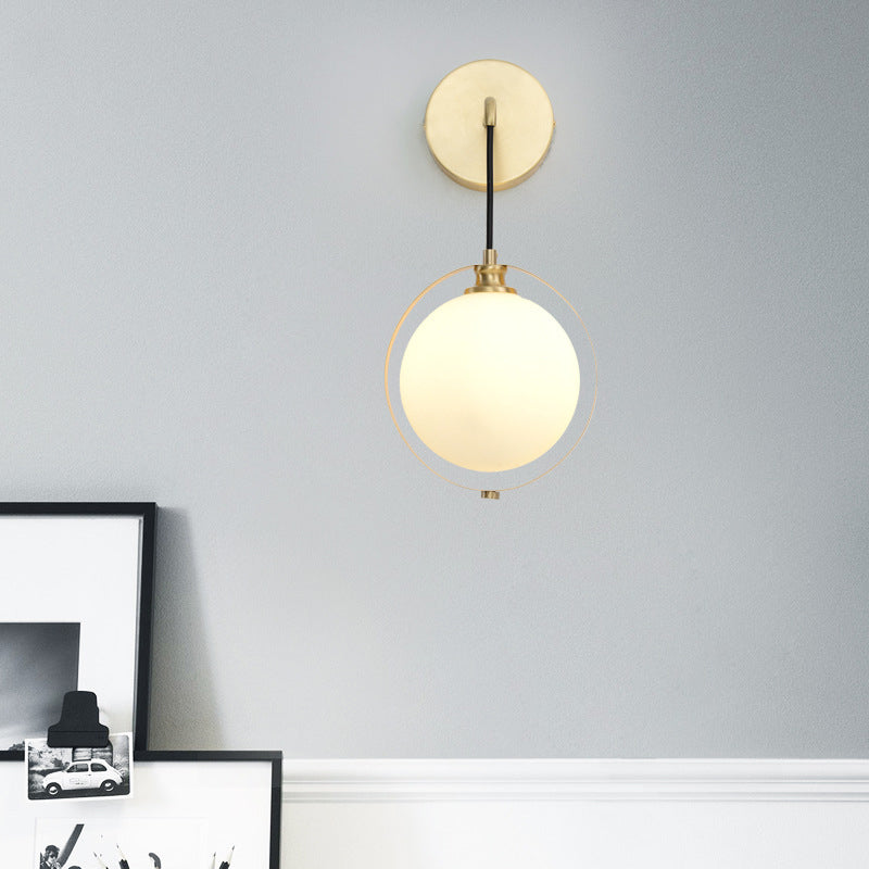 Modern White Glass Ball Sconce Light With Brass Wall Mount And Curved Arm - 1 Bulb