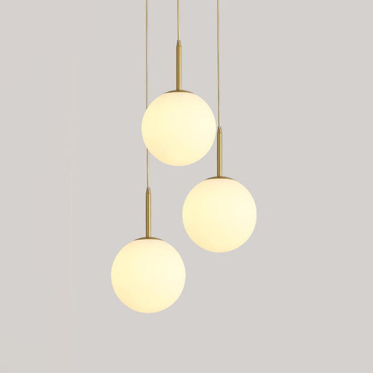 Modern White Glass Orb Hanging Ceiling Light With 3 Lights And Brass Finish