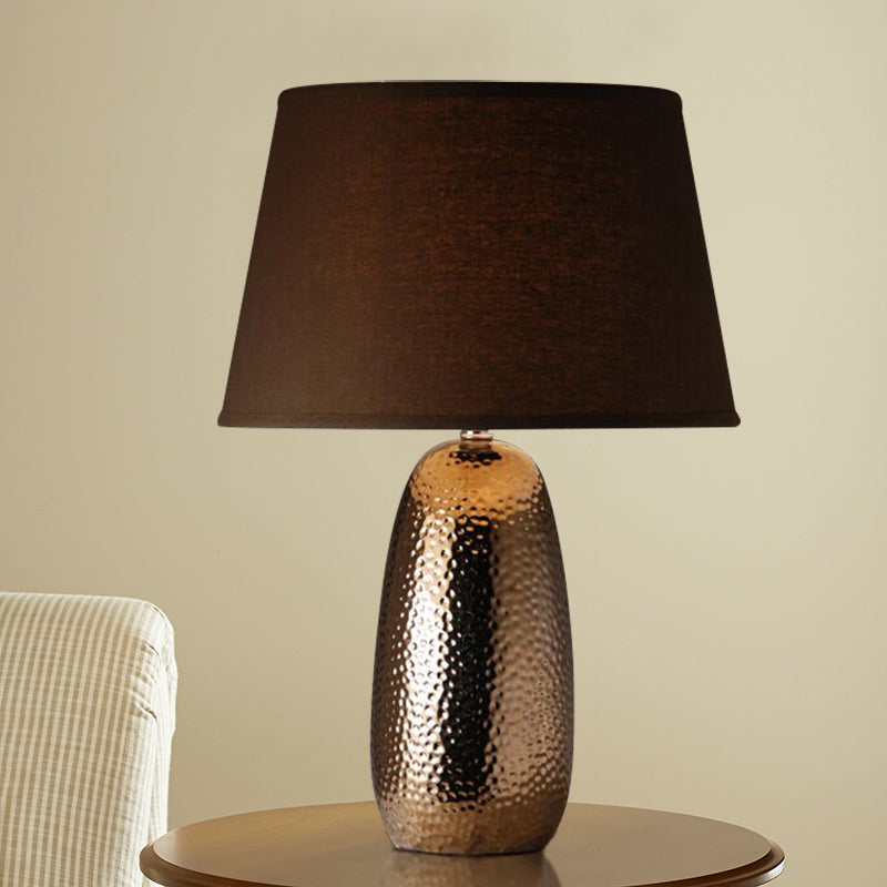 Rustic Hammered Ovoid Nightstand Lamp With Conical Fabric Shade In Brown For Bedroom