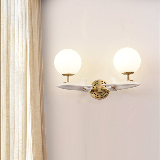 Gold Spaceship Wall Sconce With Cream Glass Globe For Kids Room - 1/2 Bulb Fixture In White &