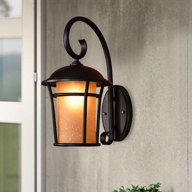 Country Black Finish Cylinder Wall Mounted Sconce With Seeded Glass And Swooping Arm