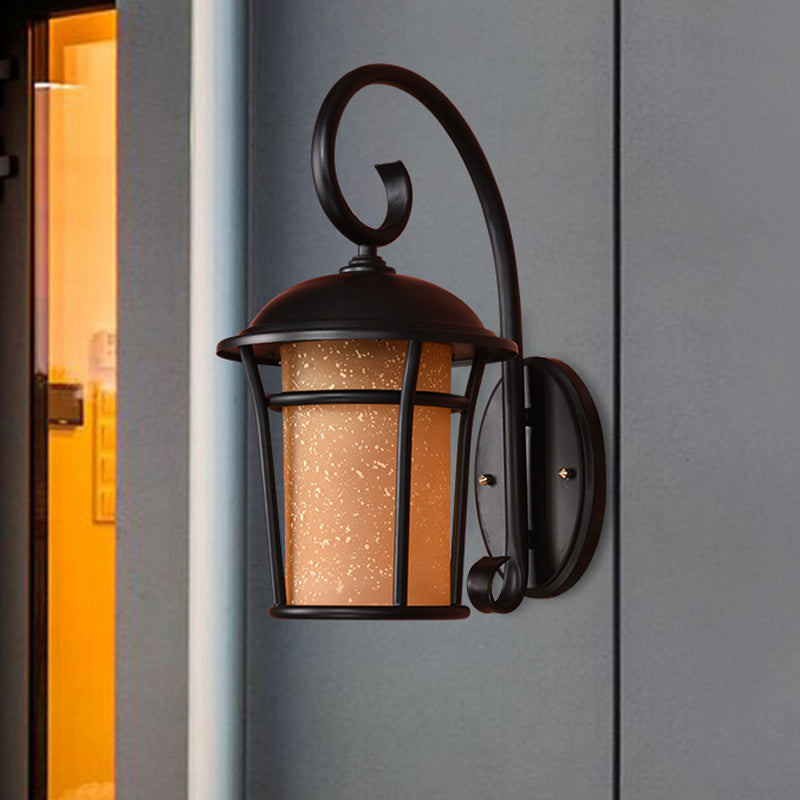 Country Black Finish Cylinder Wall Mounted Sconce With Seeded Glass And Swooping Arm