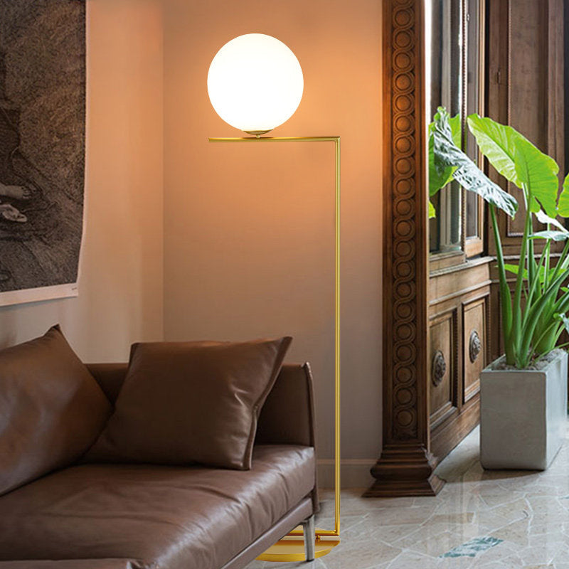 Modern Frosted Glass Spherical Floor Lamp With Gold Finish And Right Angle Arm