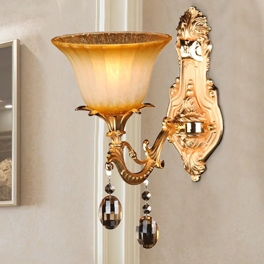 Amber Glass Wall Sconce With Brass Flower Detail For Traditional Bedroom Lighting