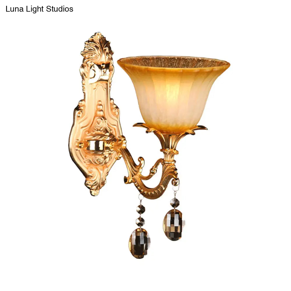 Amber Glass Wall Sconce With Brass Flower Detail For Traditional Bedroom Lighting