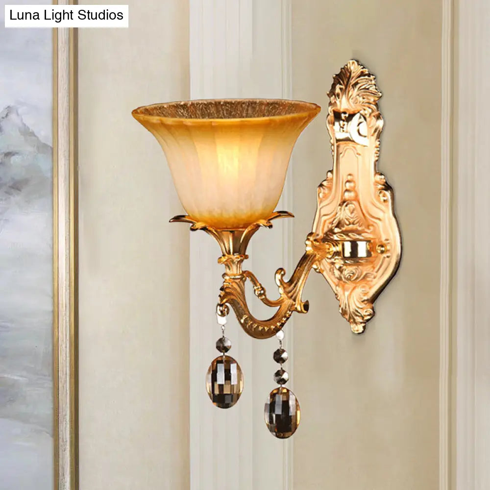 Amber Glass Wall Sconce With Brass Flower Detail For Traditional Bedroom Lighting