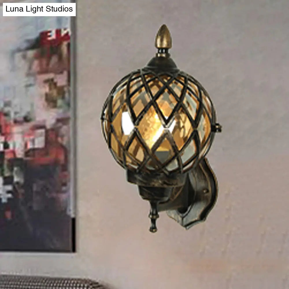 Amber Glass Wall Sconce With Industrial Cage And Black Globe For Dining Room Lighting