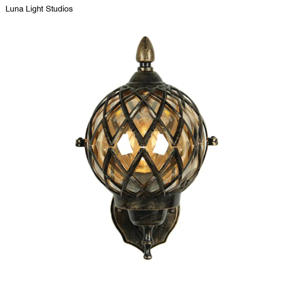 Amber Glass Wall Sconce With Industrial Cage And Black Globe For Dining Room Lighting