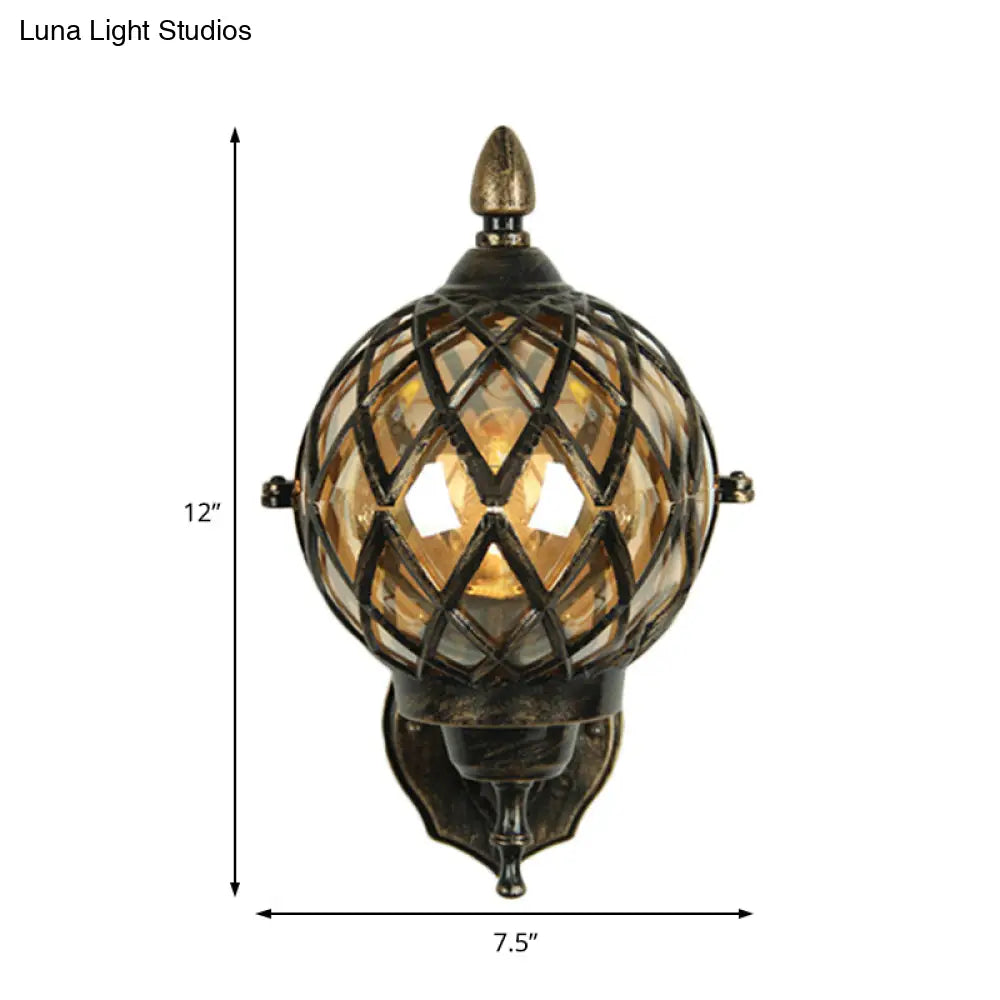 Amber Glass Wall Sconce With Industrial Cage And Black Globe For Dining Room Lighting