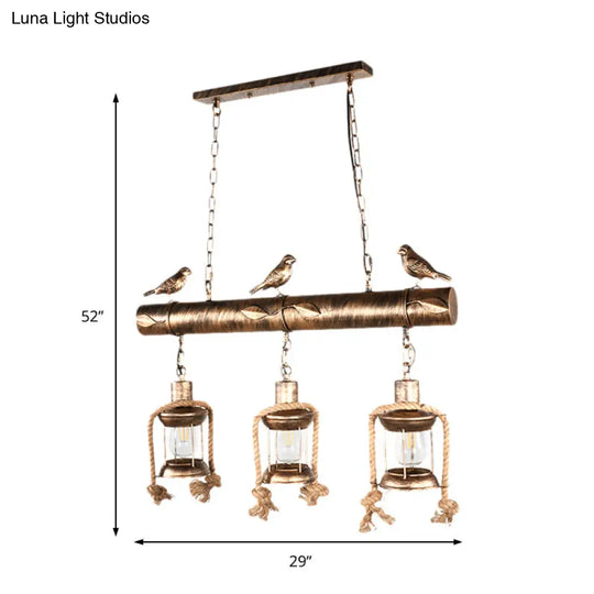 Antique Brass Lantern Pendant With Clear Glass And Bird Accent - 3-Light Coastal Island Kit