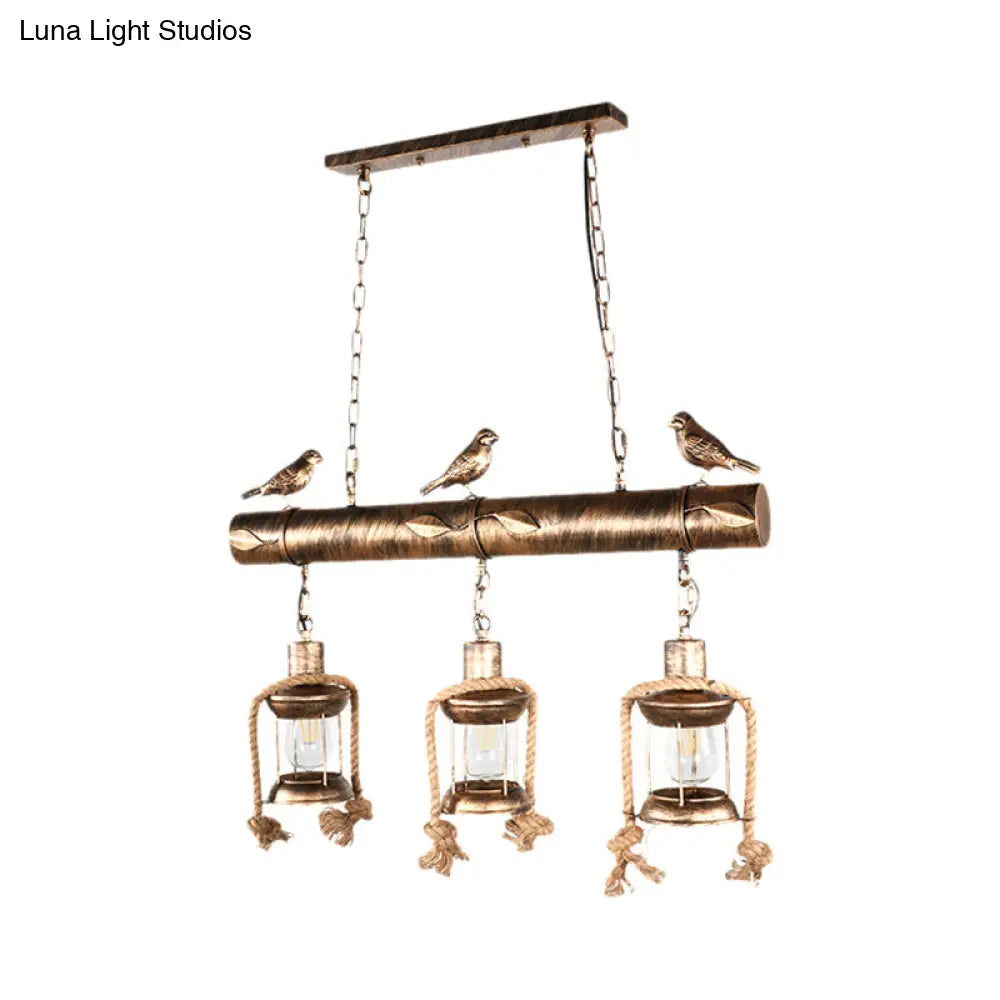 Antique Brass Lantern Pendant With Clear Glass And Bird Accent - 3-Light Coastal Island Kit