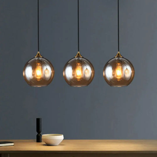 Antiqued Brass Globe Pendant Lamp With 3 Lights And Glass Shade Amber / Linear