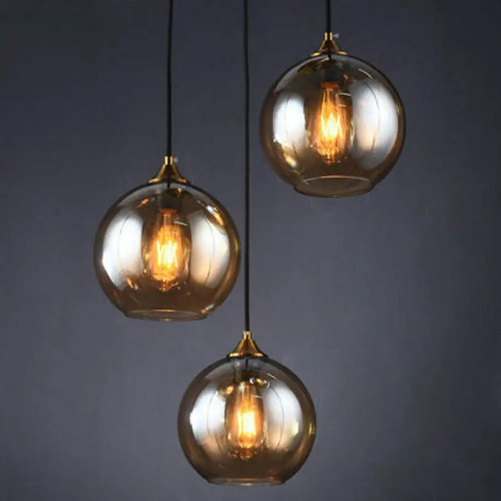 Antiqued Brass Globe Pendant Lamp With 3 Lights And Glass Shade Amber / Round