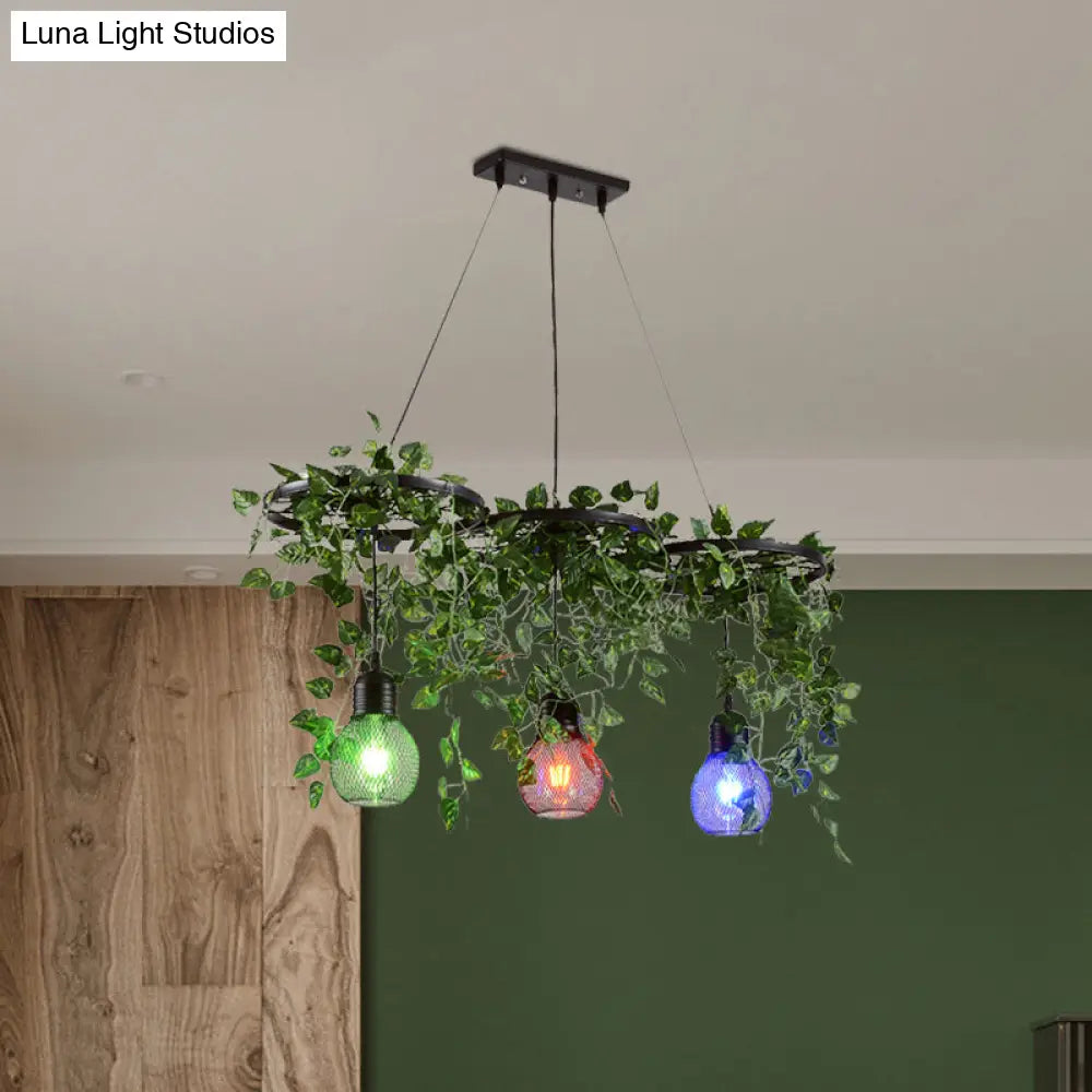 Black Iron Wheel 3-Head Pendant Light With Green Vine Detail And Globe Cage Design