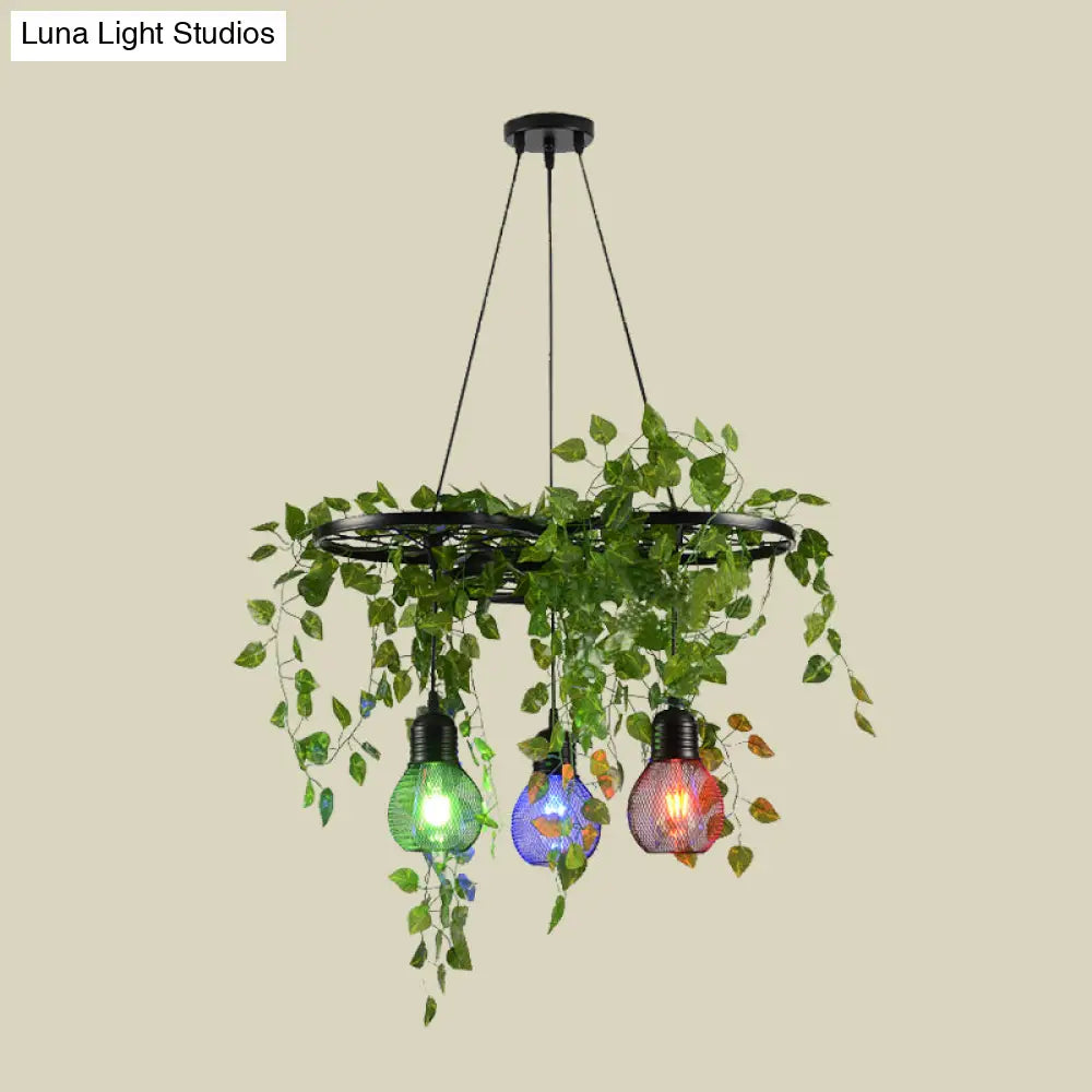 Black Iron Wheel 3-Head Pendant Light With Green Vine Detail And Globe Cage Design