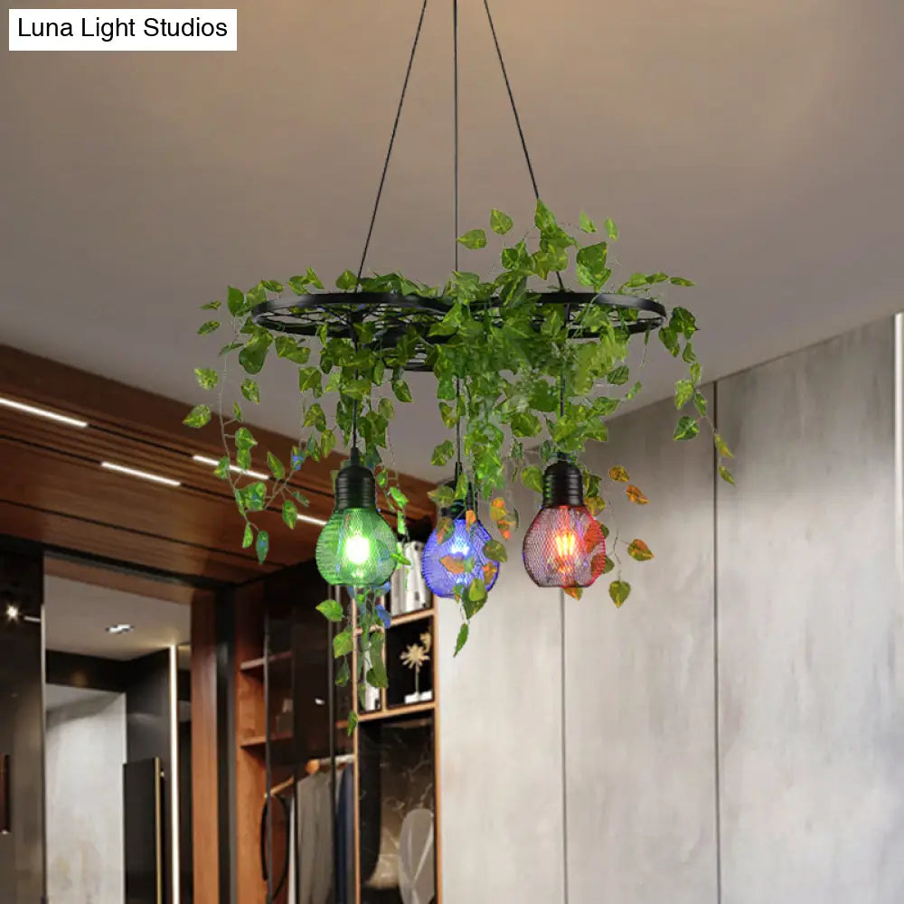 Black Iron Wheel 3-Head Pendant Light With Green Vine Detail And Globe Cage Design