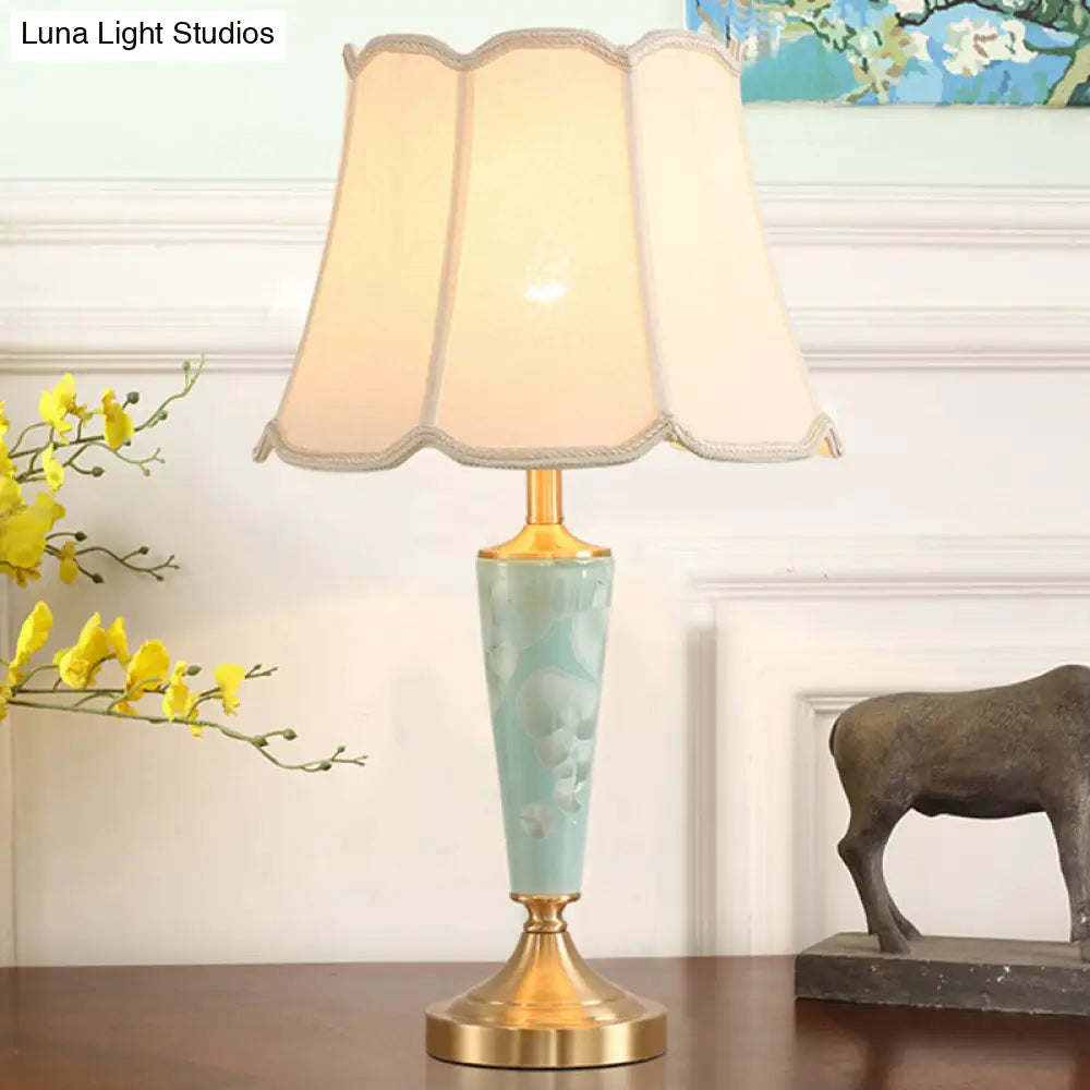 Blue Fabric Table Lamp With Scalloped Shade For A Classic Nighttime Glow