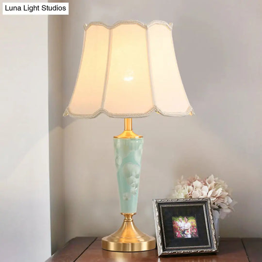 Blue Fabric Table Lamp With Scalloped Shade For A Classic Nighttime Glow