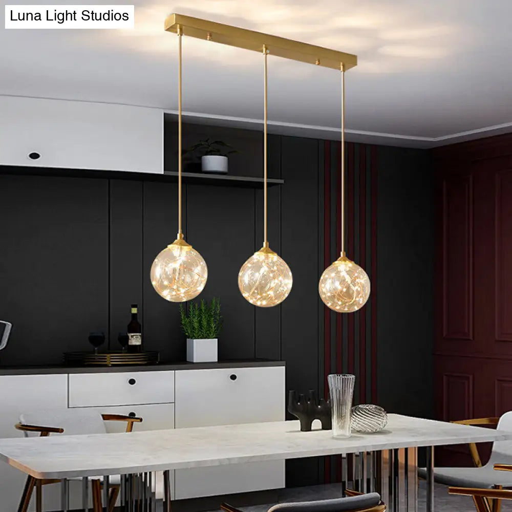 Sleek Brass Sphere Led Pendant Lamp For Modern Dining Rooms