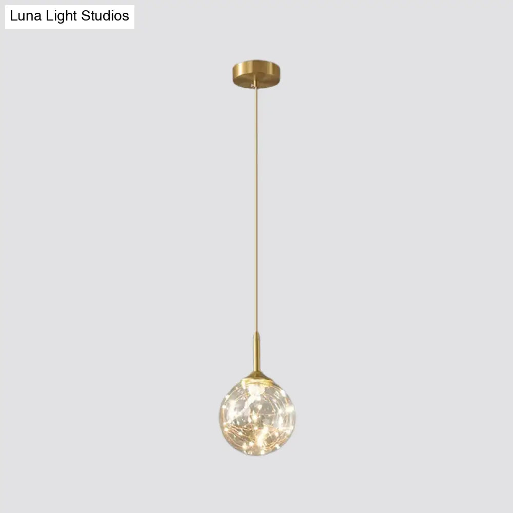 Sleek Brass Sphere Led Pendant Lamp For Modern Dining Rooms