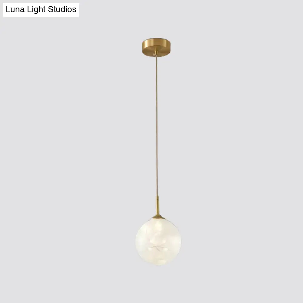 Sleek Brass Sphere Led Pendant Lamp For Modern Dining Rooms