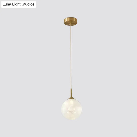 Sleek Brass Sphere Led Pendant Lamp For Modern Dining Rooms