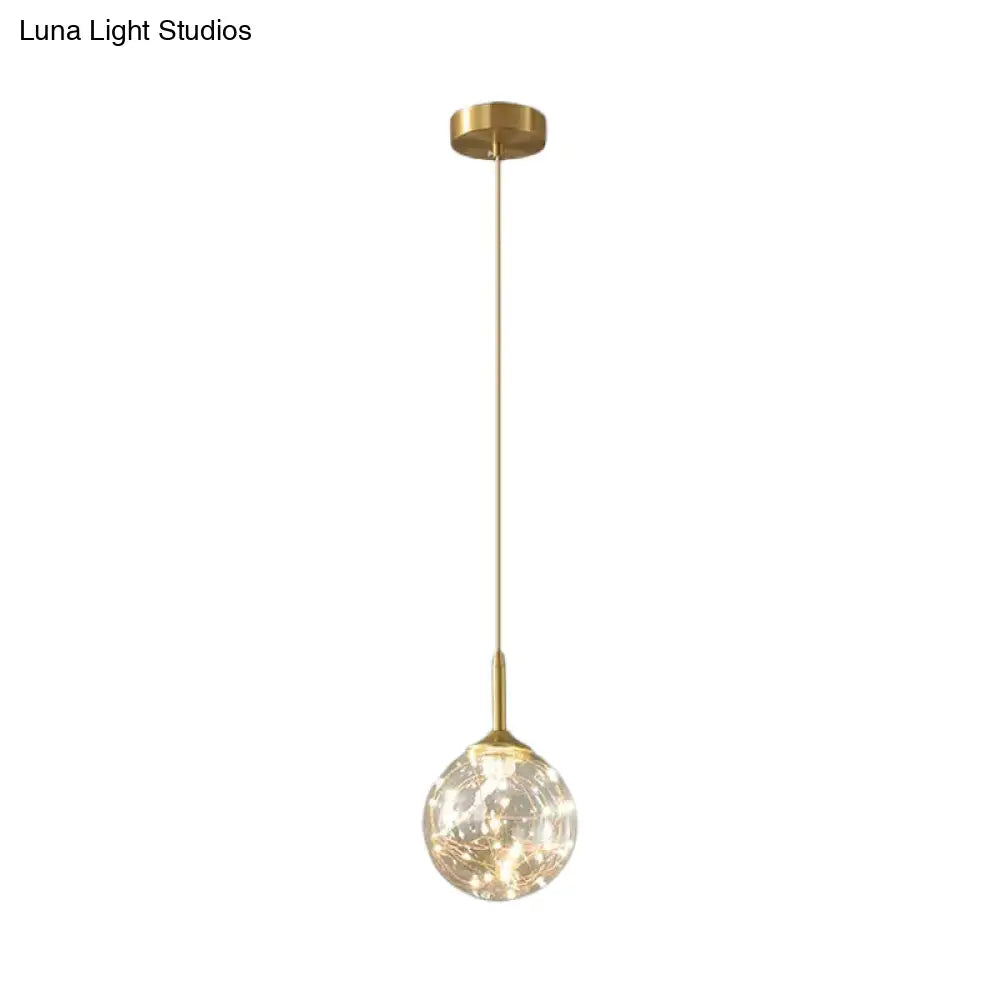 Sleek Brass Sphere Led Pendant Lamp For Modern Dining Rooms