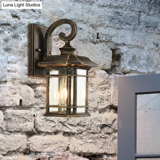 Bronze Curvy Arm Outdoor Wall Sconce With Clear Ripple Glass