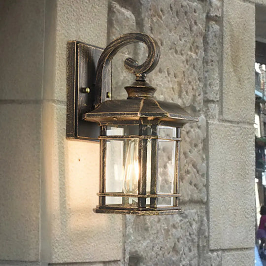 Bronze Curvy Arm Outdoor Wall Sconce With Clear Ripple Glass