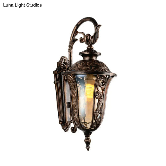 Bronze Metal Outdoor Wall Sconce With Curved Arm Amber Glass Shade - 1-Light Lamp