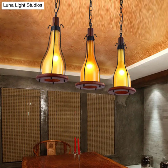 Industrial Chic 3-Light Cluster Pendant With Brown Bottles And Yellow/White Glass For Dining Room